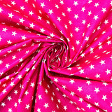 115CM PRINTED POLY COTTON WHITE STARS PINK BACKGROUND